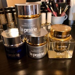 Empty jars of La Prairie & Dior skin care products
